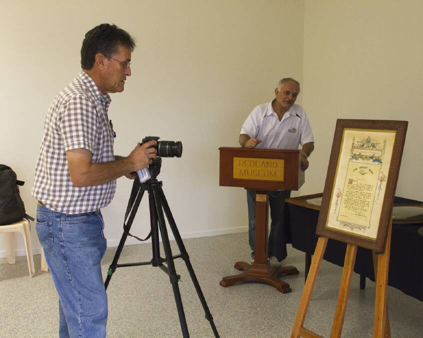 Len Davey (left) and John Kolcze photograph items for the digital record.  
 
Photo by Karolyn Campbell