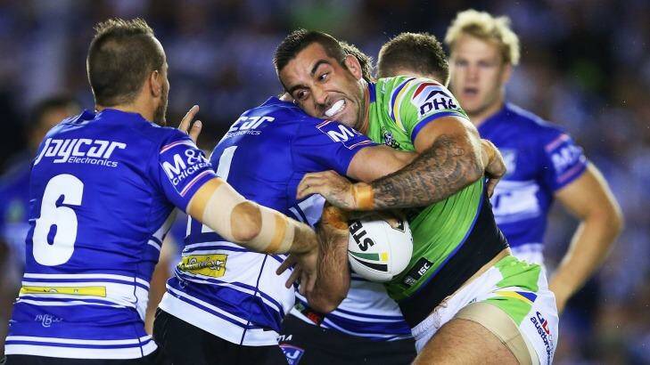 Paul Vaughan is tackled by the Bulldogs defence. Photo: Brendon Thorne
