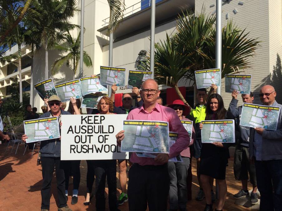 Rushwood Estate resident Daniel Kohler with some of the protesters outside chambers. Mr Kohler said 6m cul-de-sacs, Caldwell Close and Whitby Place, were not designed to carry the expected volume of traffic to the Ausbuild estate, which also borders a Fiteni Homes project.