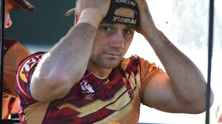 Painful exit: Queensland halfback Cooper Cronk is driven away for treatment after suffering an ankle injury during the Maroons training session at Sanctuary Cove on Friday.