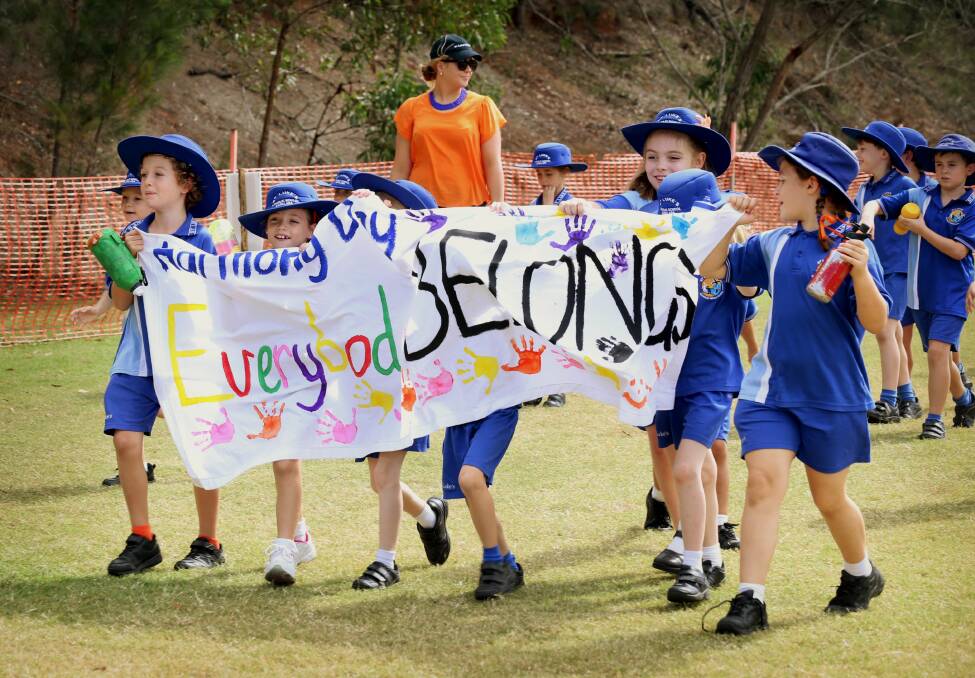 Students from Saint Luke s Catholic Primary School take part in a school walkathon for Harmony Day.  
Photo by Adam Armstrong