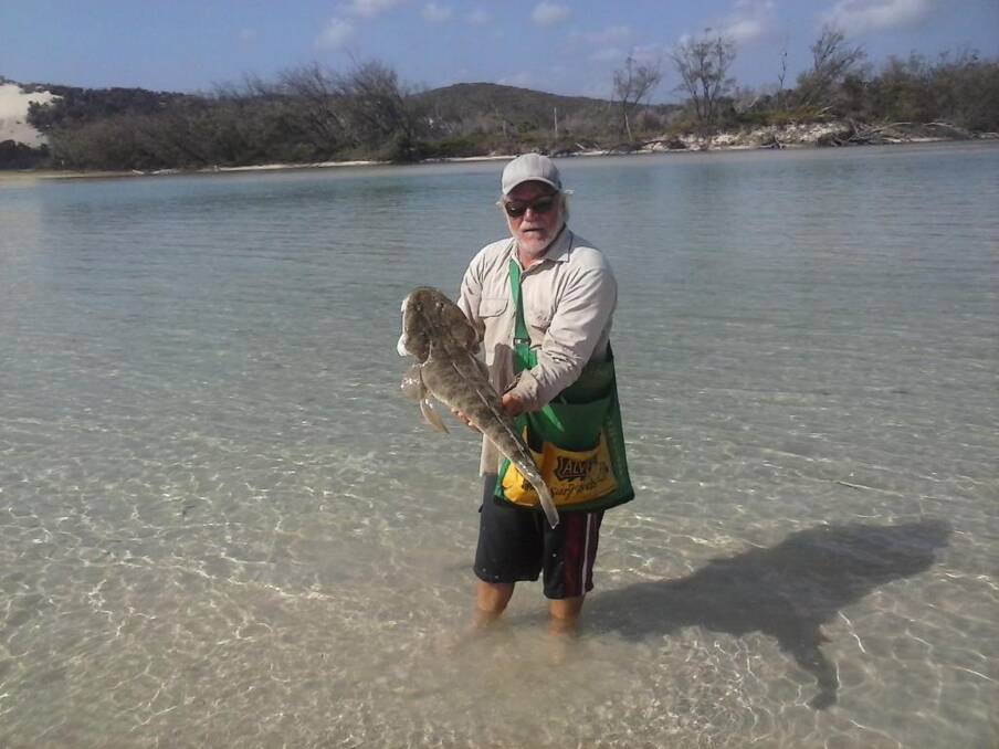 Harry McMillan with an oversize flathead caught and released from Moreton Island.
