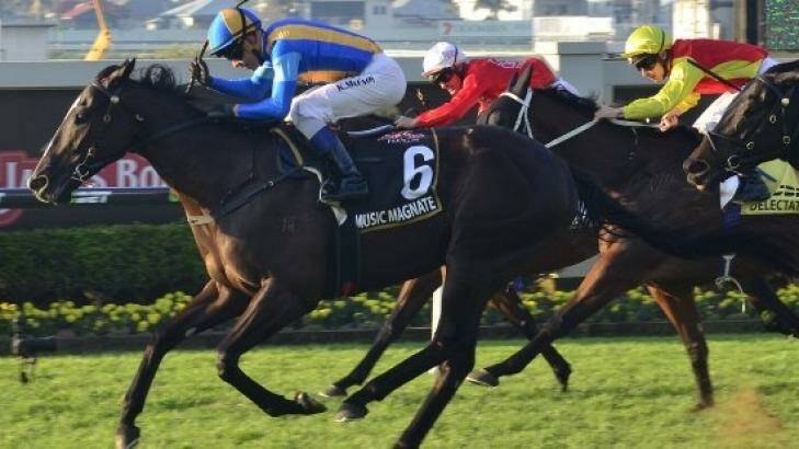 Frenetic race: Bjorn Baker claims his maiden group 1 win with Music Magnate in the Doomben 10,000. Photo: Racing Queensland