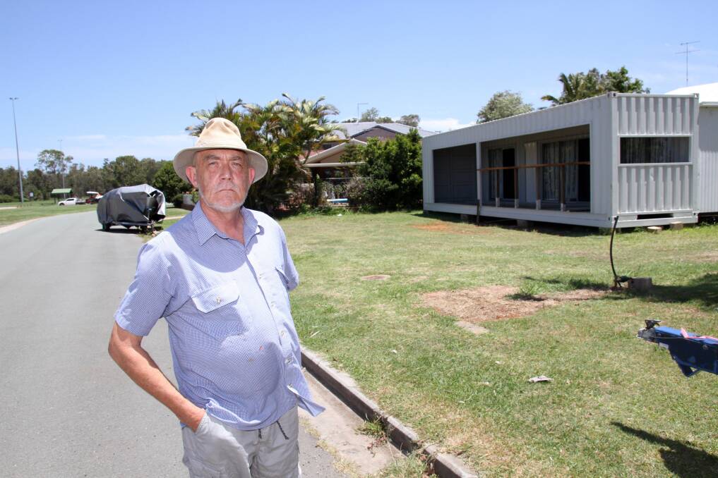 Esplanade, Redland Bay resident Ted Wearne is concerned a container on neighbouring land could be a hazard in a storm. 
Photo by Chris McCormack