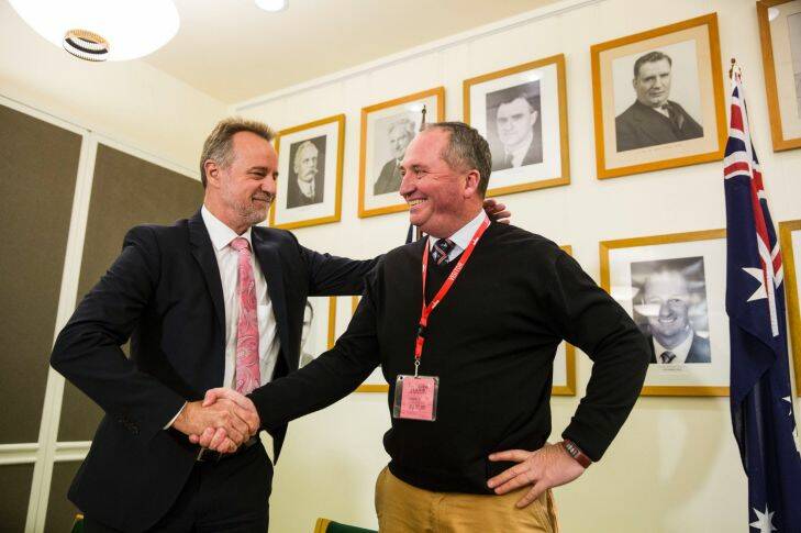 Indigenous Affairs Minister Nigel Scullion congratulates re-elected Nationals Leader Barnaby Joyce at a Nationals party meeting at Parliament House in Canberra on the 4th of December 2017. FedPOL. Photo Dominic Lorrimer