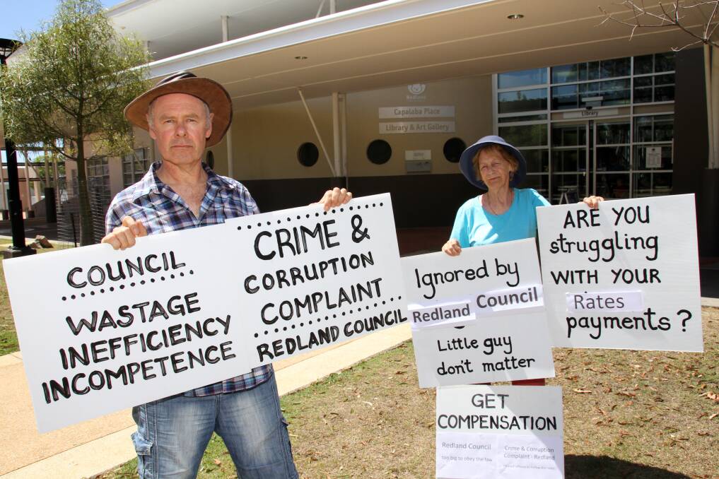 Paul and Ruth Herman, of Broadbeach Waters, protest at the Redland City Council auction of properties to recover rates. 
 Photos by Chris McCormack