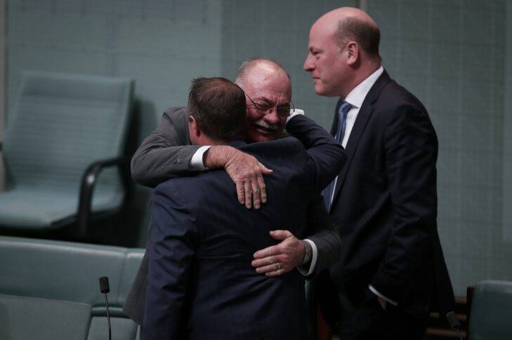 Liberal MP Tim Wilson is embraced by colleague Warren Entsch after speaking during debate on the Marriage Amendment Bill in the House of Representatives at Parliament House in Canberra on  Monday 4 December 2017. fedpol Photo: Alex Ellinghausen