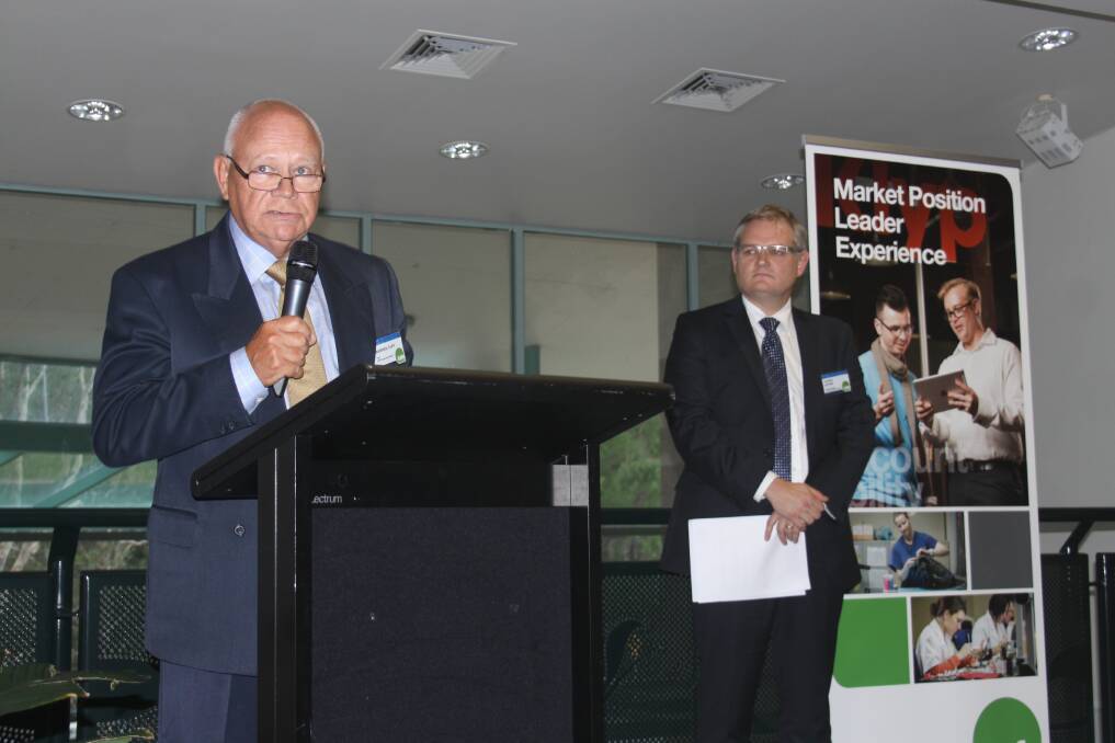 TAFE Queensland board chairman Warren Tapp addresses the audience in Alexandra Hills on Thursday night as the organisation's Brisbane director, Aaron Devine, looks on. Photo by Stephen Jeffery.
