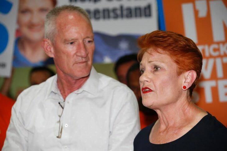One Nation leader and senator Pauline Hanson flanked by state leader Steve Dickson and party supporters speaks to the media upon arrival from India at the Brisbane International airport in Brisbane, Sunday, November 5, 2017. Pauline Hanson attended trade talks in India. (AAP Image/Regi Varghese) NO ARCHIVING