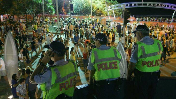 Police watch over revelers at schoolies on the Gold Coast. Photo: Sergio Dionisio