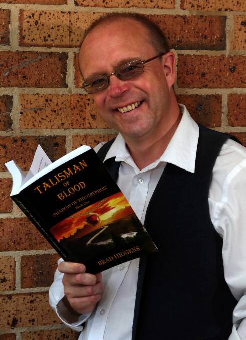Cleveland author Brad Higgens with his novel, Talisman of Blood. Photo by Stephen Archer