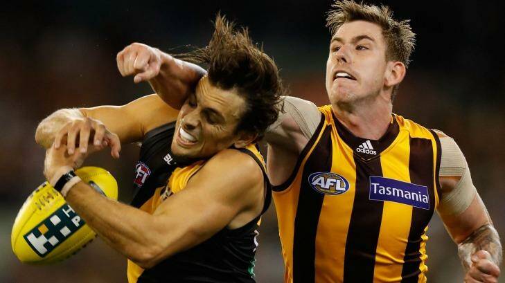 Sam Lloyd of the Tigers is taken high by Kaiden Brand of the Hawks. Photo: AFL Media/Getty Images