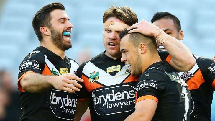 Tigers players celebrate a try by Luke Brooks.