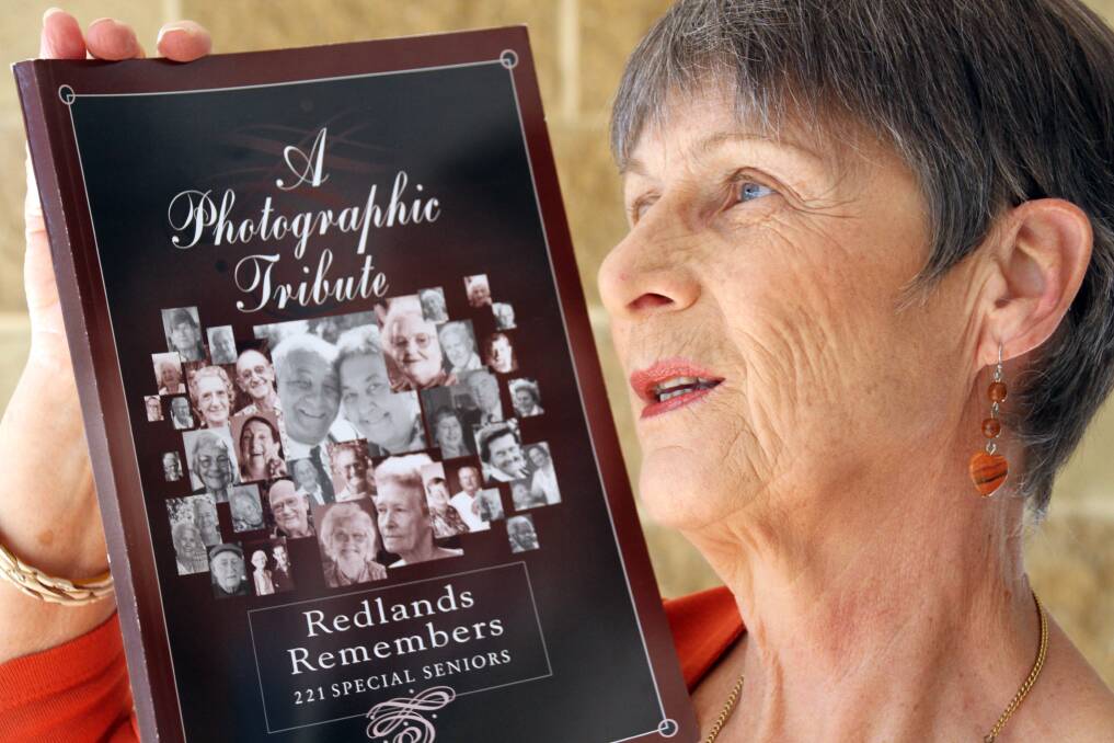 Susan Russell holds the book of photographic tributes of people in the Redlands. An exhibition will be held at Redland Museum in August/September .Photo by Chris McCormack