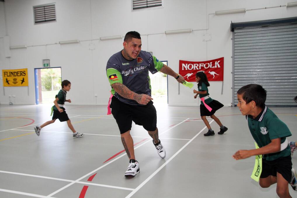 Jesse Williams tries to catch grade 2 student Maicah Lowe in a game of tag at Vienna Woods State School last year.Photo by Chris McCormack