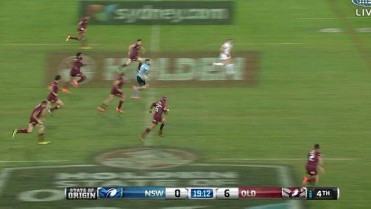 Blue streak: Dugan leaves the Maroons' defence for dead. Photo: Channel Nine