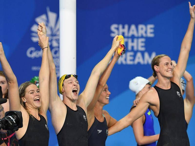 The Australian women's 4x100m freestyle team, including Shayna Jack, celebrate their Games win and world record. 