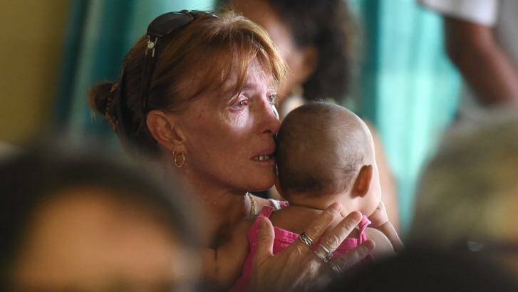 A woman reacts during a church service to remember eight children who were allegedly stabbed to death by their mother in the Cairns suburb of Manoora,  Photo: Dan Peled