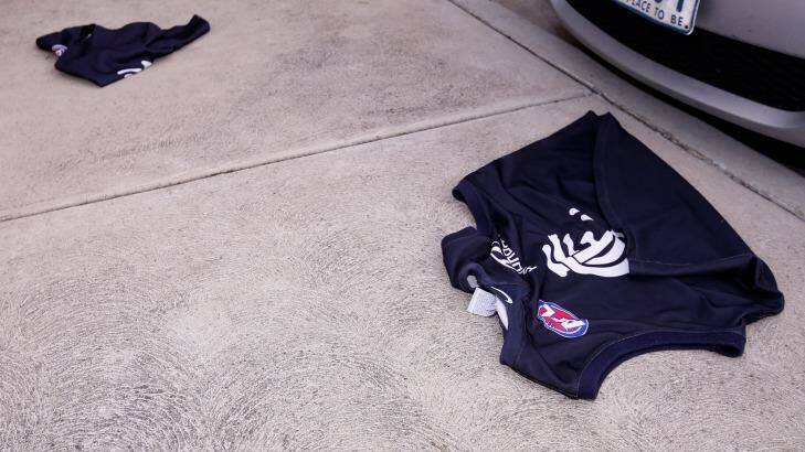 Carlton jumpers lie on the ground outside Princes Park after an angry fan threw them away on Tuesday. Photo: Darrian Traynor