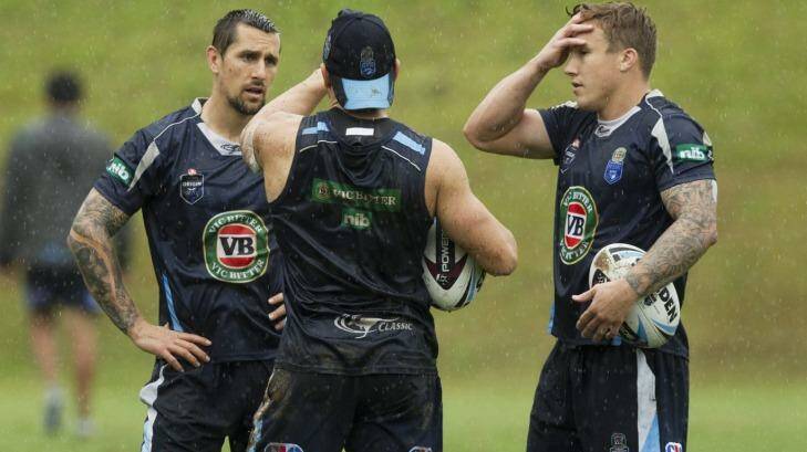 Feeling the heat: Blues halves Mitchell Pearce (left) and Trent Hodkinson (right) talk things over at training in Coffs Harbour with Robbie Farah. Photo: James Brickwood