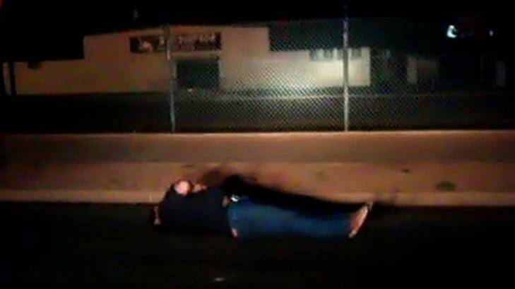 The man lies on the ground after being tasered. Photo: Supplied
