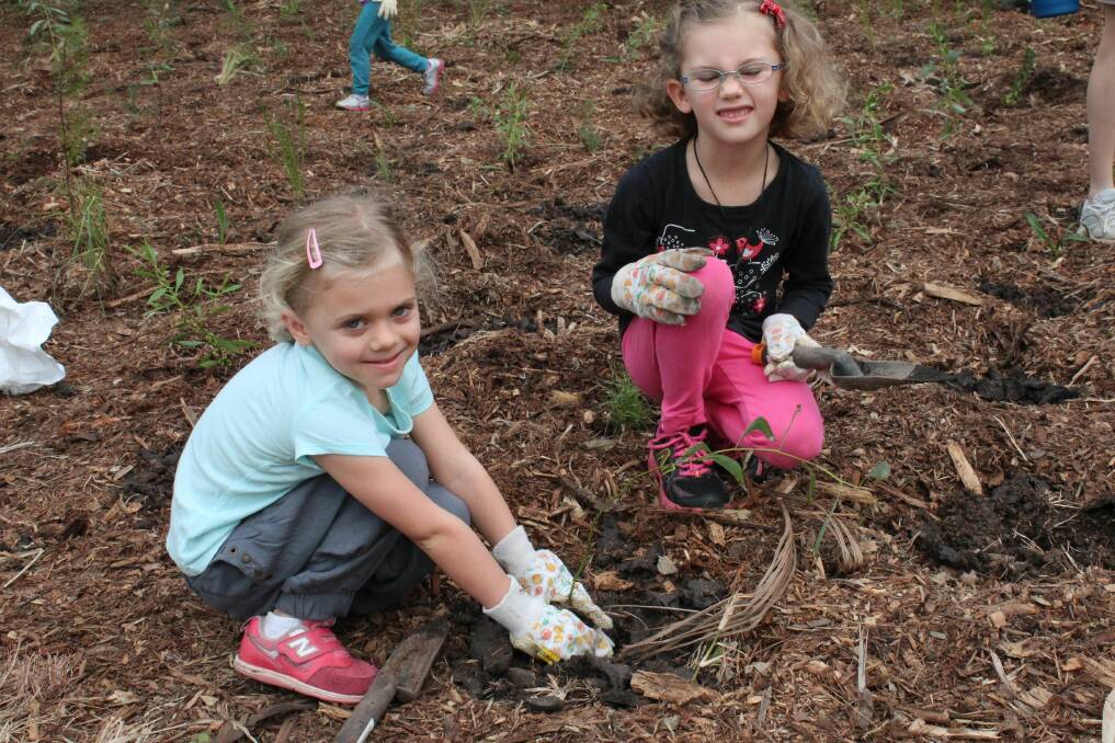 Sarah and Myah Williams, of Alexandra Hills, had fun at the IndigiScapes planting on National Tree Day.