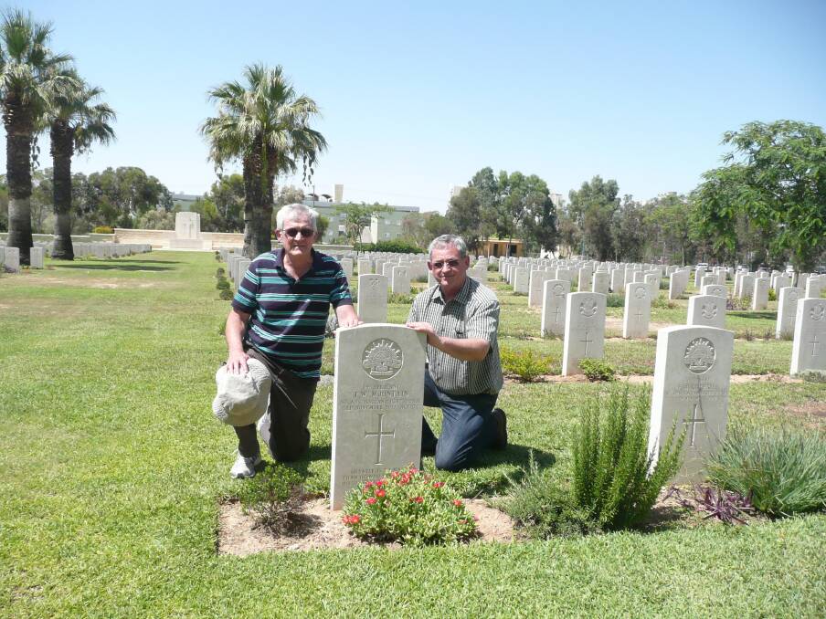 Great nephews of Sergeant Tom Mountain, Roy (left), of Westleigh in Sydney, and Jeff Freak, of Cleveland, tend the grave of their great "Uncle Tom" at the Beersheeba War Cemetery in southern Israel.
