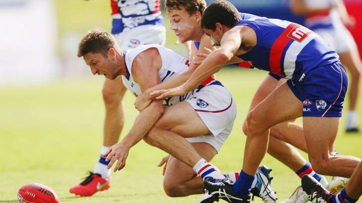 Matthew Boyd (left) competes for the ball against Mitch Wallis and Tom Liberatore (right) during the Western Bulldogs intra-club match at Whitten Oval on Saturday. Photo: Michael Dodge