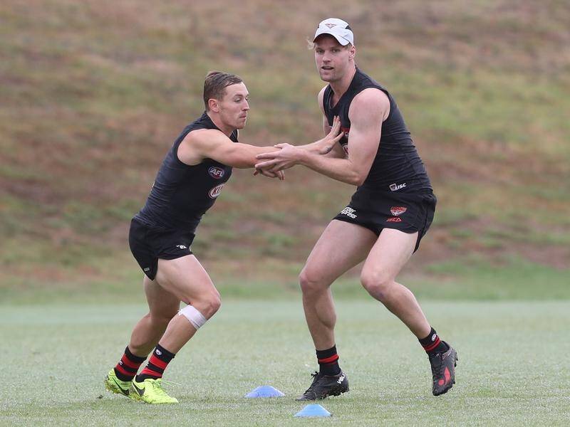 Essendon will play recruits Devon Smith (L) and Jake Stringer in their AFL pre-season opener.