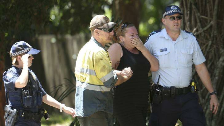 A woman reacts at the scene in Murray St Manoora in Cairns where the mutliple stabbing occured. Photo: Dominic Chaplin