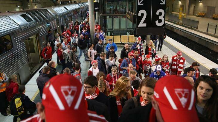 Sydney Swans fans arrive at Olympic Park station for Friday's preliminary final. The scramble to make it to the Melbourne grand final is on. Photo: Don Arnold