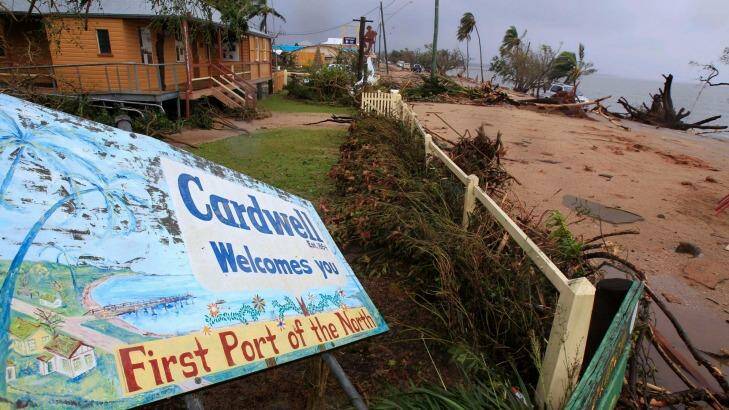 A welcome sign is knocked down by Cyclone Yasi in Cardwell. Photo: Rick Rycroft