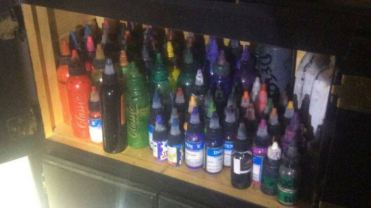 Police officers found tattoo guns, ink bottles and sketchbooks during a raid on an alleged backyard tattoo shop on the Gold Coast. Photo: Queensland Police Service