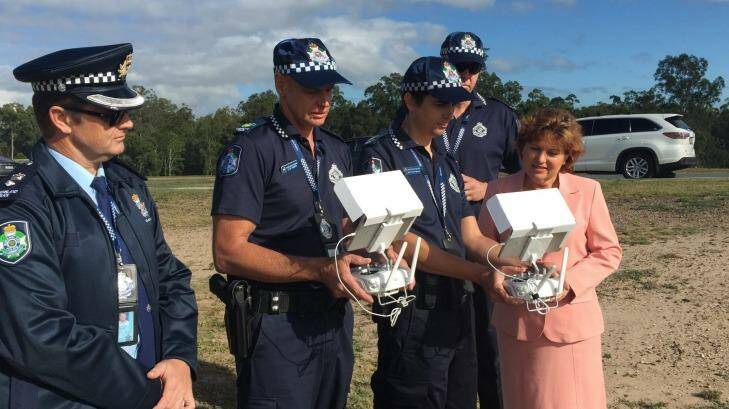 Police Minister Jo-Ann Miller and members of the QPS Photographic Services branch examine the RPA controls. Photo: Supplied
