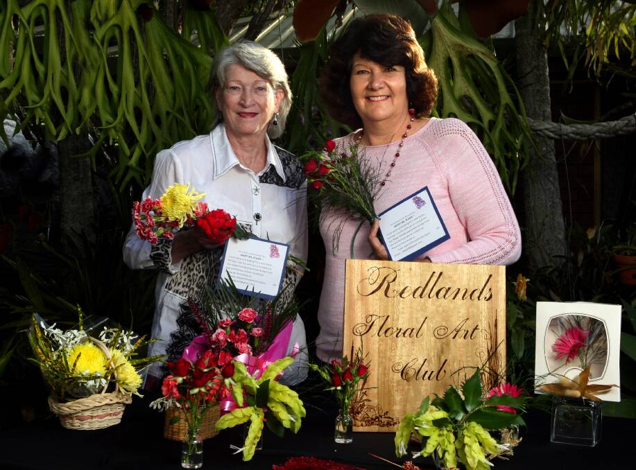 Flower Power: Redland Floral Art Group president Irene Corbett, of Birkdale, and treasurer and Val Decker, are preparing for International Bouquet Day. They plan to deliver at least 50 bouquets to anonymous recipients. All they ask in return is that people email them to say they received a bouquet. Delivery date is June 29.