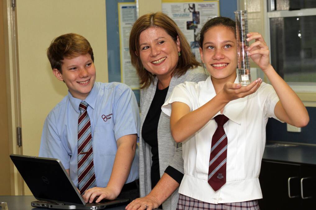 Ormiston College students Noah Wechgeluer and Jordan Taulilo, both 13 years old, in the science lab with Microsoft academics program manager Jane Mackarell. 
Photos by Chris McCormack
