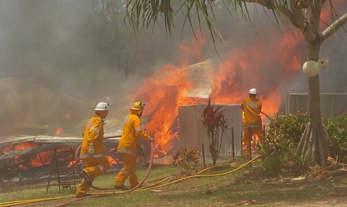 Firies fight the fire on Macleay Island which has left a family homeless over Christmas. PHOTOS: Lucy Celik