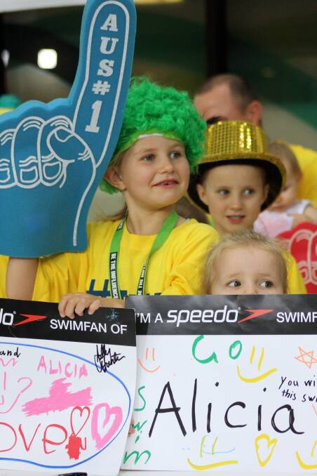 April 2 - Australian Swimming Championships trials at Chandler. Alicia Coots fans' Fiona O' Meara, 7 (in wig) and her family cheer on .
Photo by Chris McCormack