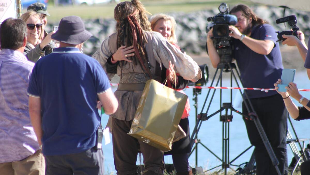 Redland Mayor Karen Williams gets a hug from Johnny Depp at Raby Bay. PHOTO: Chris McCormack