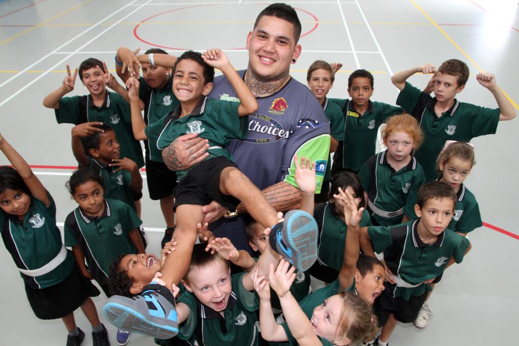  March 12 - 'Tha Monster' Jesse Williams holds Vienna Woods State School grade 2 student Desmond Watego aloft as other students hearing the " Deadly Choices" message look on.
Photo by Chris McCormack