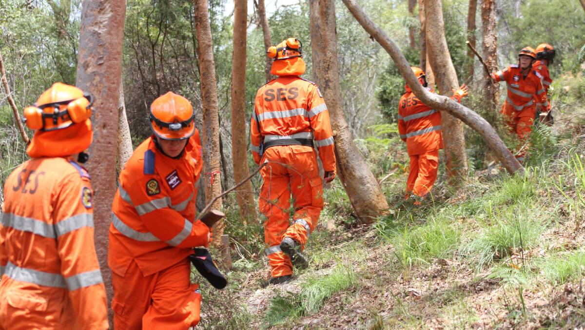 january 8 - SES volunteers clear a fire break in the battle to quell the North Stradbroke Island fires.
Photo by Chris McCormack
