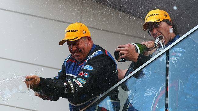 Bathurst 1000 winners Mount Cotton's Paul Morris and Jimboomba's Chaz Mostert spray Sirromet wine on the podium after winning at Mount Panorama on the weekend. 
 