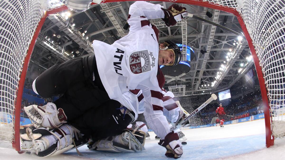 Sandis Ozolins #8 collides with Edgars Masalskis #31 of Latvia in the third period against Switzerland during the Men's Ice Hockey Preliminary Round Group C game on day five of the Sochi 2014 Winter Olympics at Shayba Arena on February 12, 2014 in Sochi, Russia. Photo: GETTY IMAGES