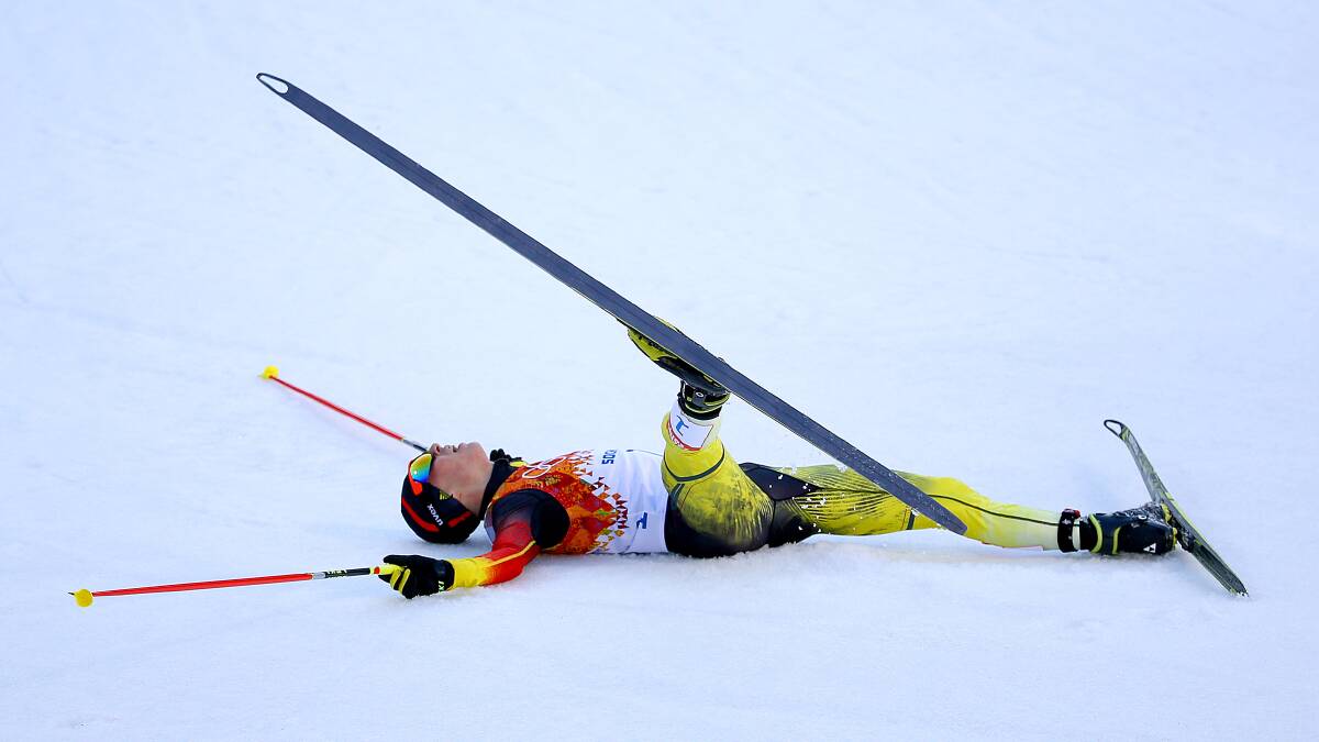 Eric Frenzel of Germany collapses as he wins the gold medal during the Nordic Combined Individual Gundersen Normal Hill and 10km Cross Country on day 5 of the Sochi 2014 Winter Olympics at the RusSki Gorki Nordic Combined Skiing Stadium on February 12, 2014 in Sochi, Russia. Photo: GETTY IMAGES