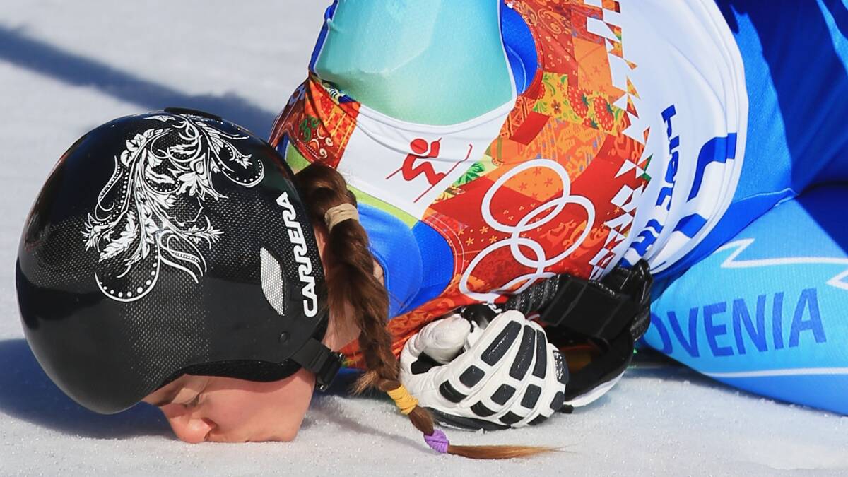 Tina Maze of Slovenia kisses the ground after her run during the Alpine Skiing Women's Downhill on day 5 of the Sochi 2014 Winter Olympics at Rosa Khutor Alpine Center on February 12, 2014 in Sochi, Russia. Photo: GETTY IMAGES