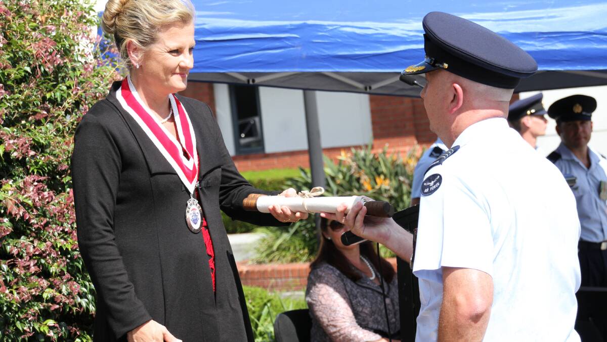 RAAF Freedom of Entry to Redland City: Redland Mayor Karen Williams hands the scroll declaring Freedom of Entry to parade leader Group Captain Peter Davis. Photo by Chris McCormack
