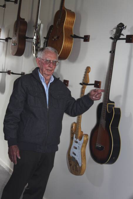 Merv French points out some of the guitars left behind in his collection after a burglary this week. Photo by Stephen Jeffery.