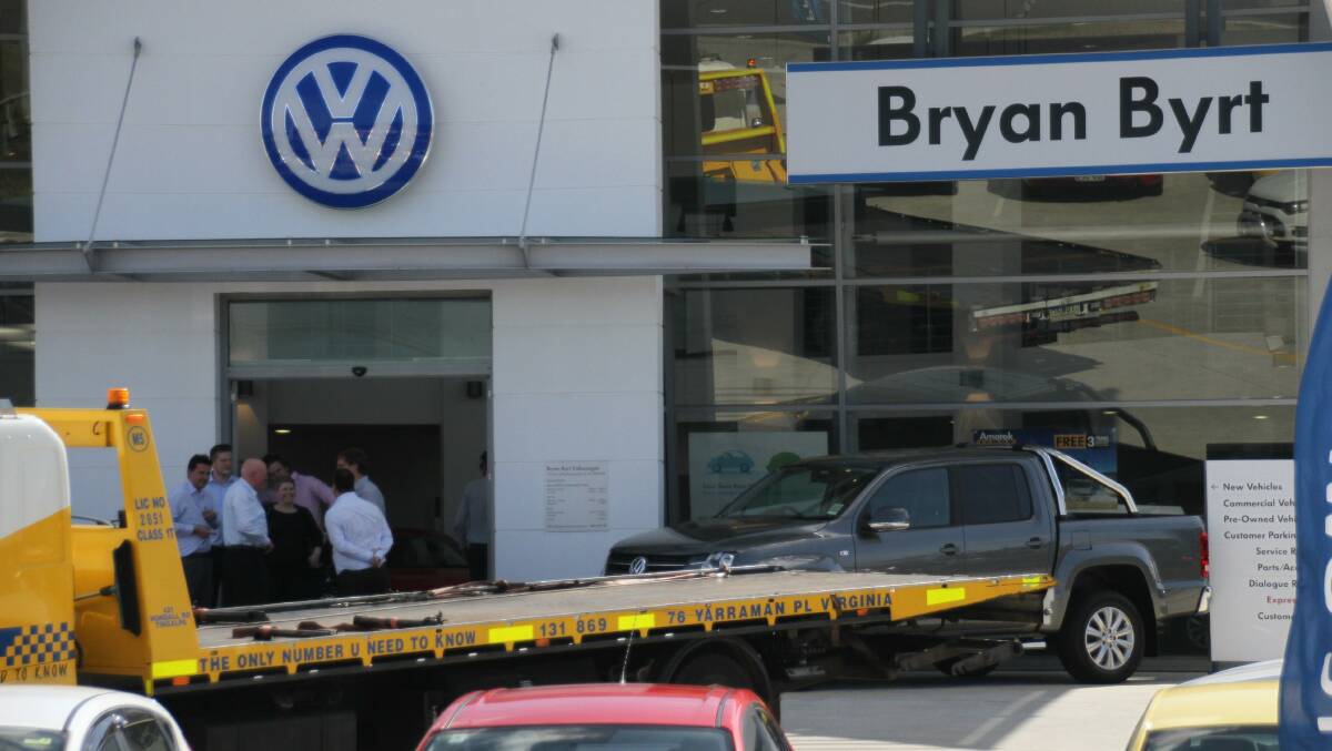 Tow trucks load cars from the Bryan Byrt VW dealership at Capalaba on Friday. Photo: Chris McCormack 