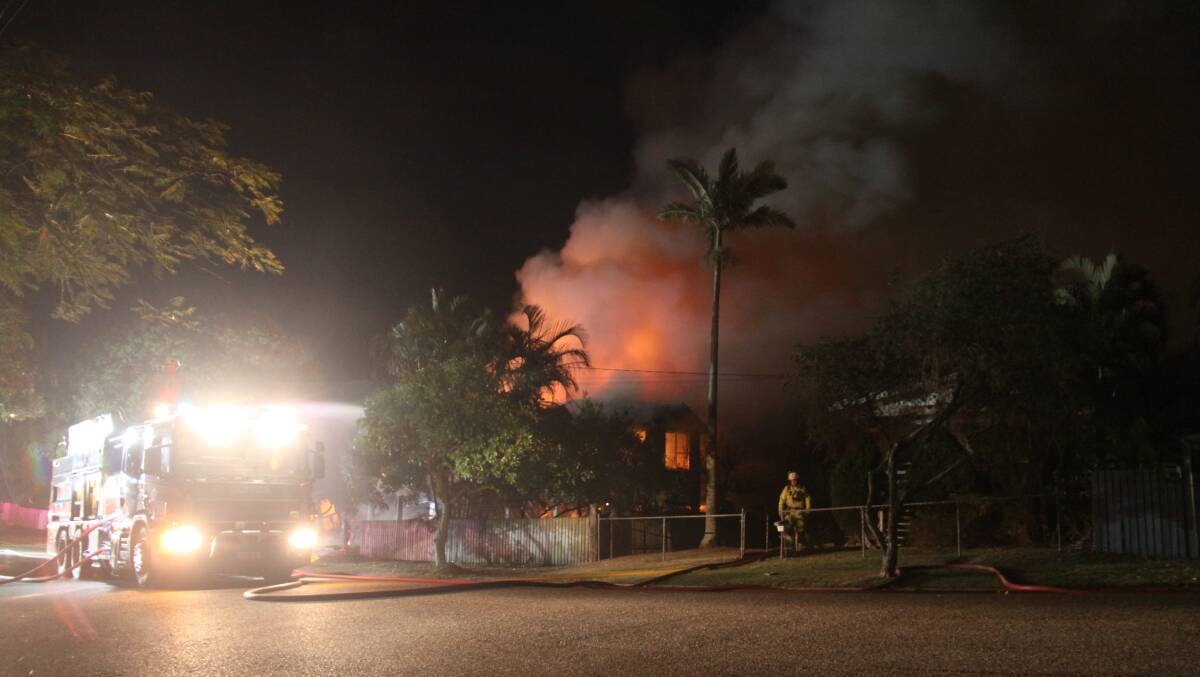 Fire fighters at the scene of the fire in Wynnum.  Photo: GRANT SPICER 
