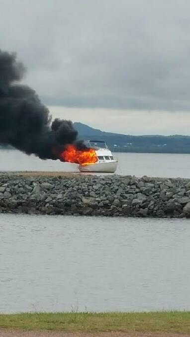 This photo by LUKE SIMPSON shows the boat well alight before fire crews reached it. 
